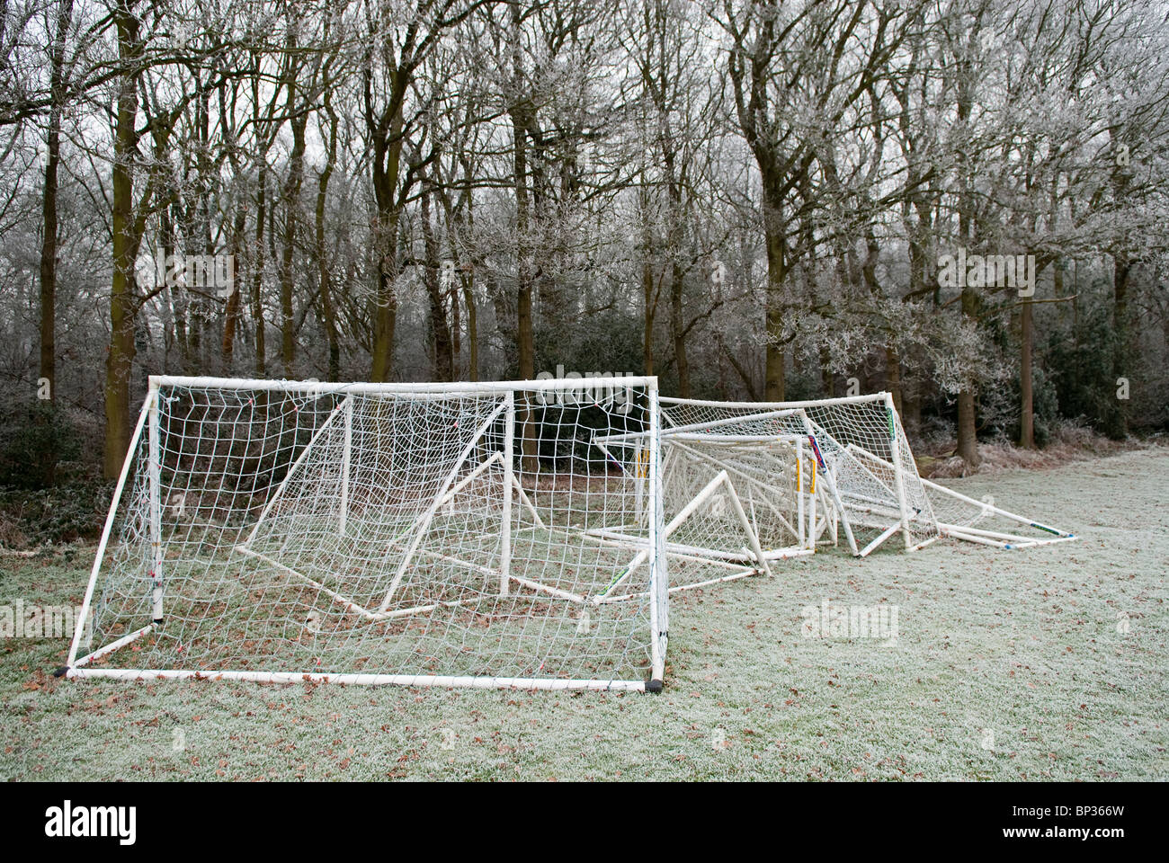 football, soccer, goals jumbled in a pile on a frosty day Stock Photo
