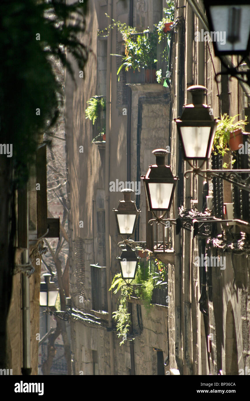 Street lamps in Calle de la Força with window boxes on wrought iron balconies in 'El Call', the Jewish Quarter of Girona Stock Photo
