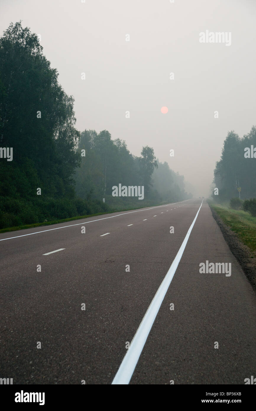 A road in smog of forest fires Stock Photo