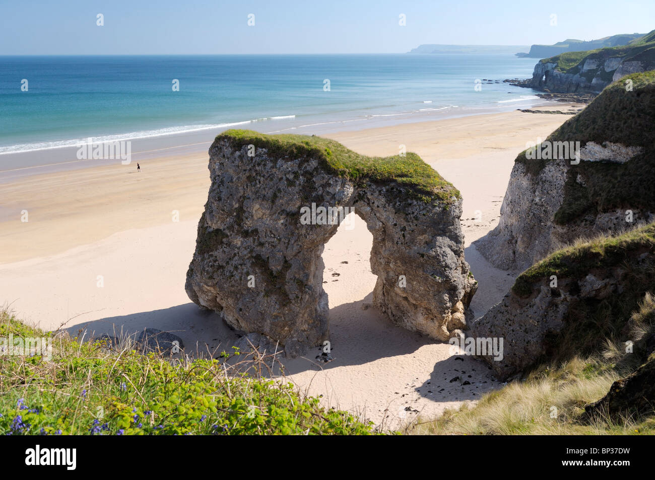 Man running along deserted beach at the White Rocks between Portrush