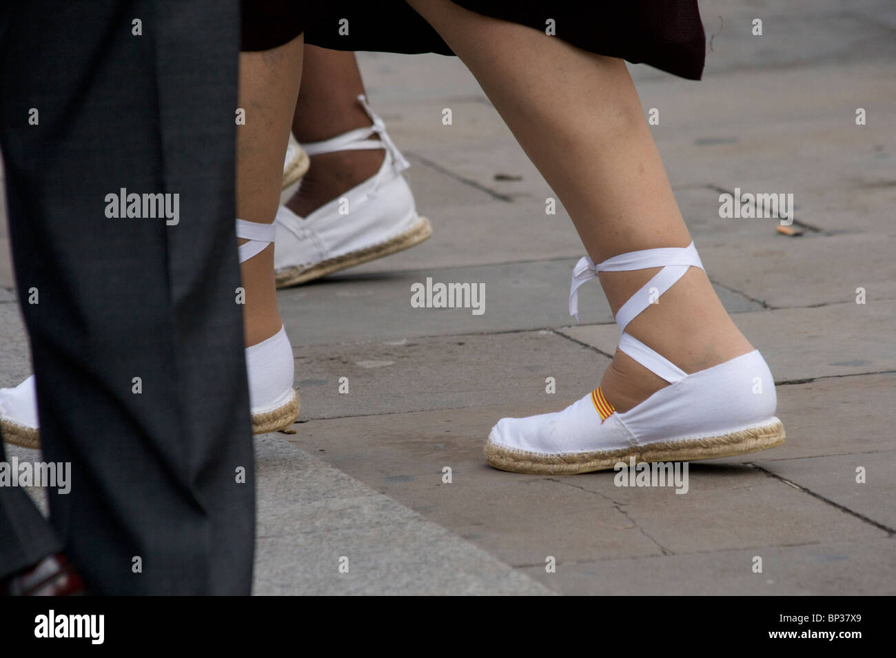 Young people, wearing special white canvas and ribbon espadrilles, dancing  the traditional Catalonian dance of the 'Sardana' Stock Photo - Alamy