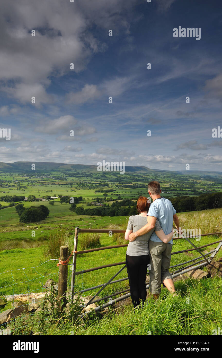 A young couple look across to the Bowland Fells from Jeffery Hill on ...