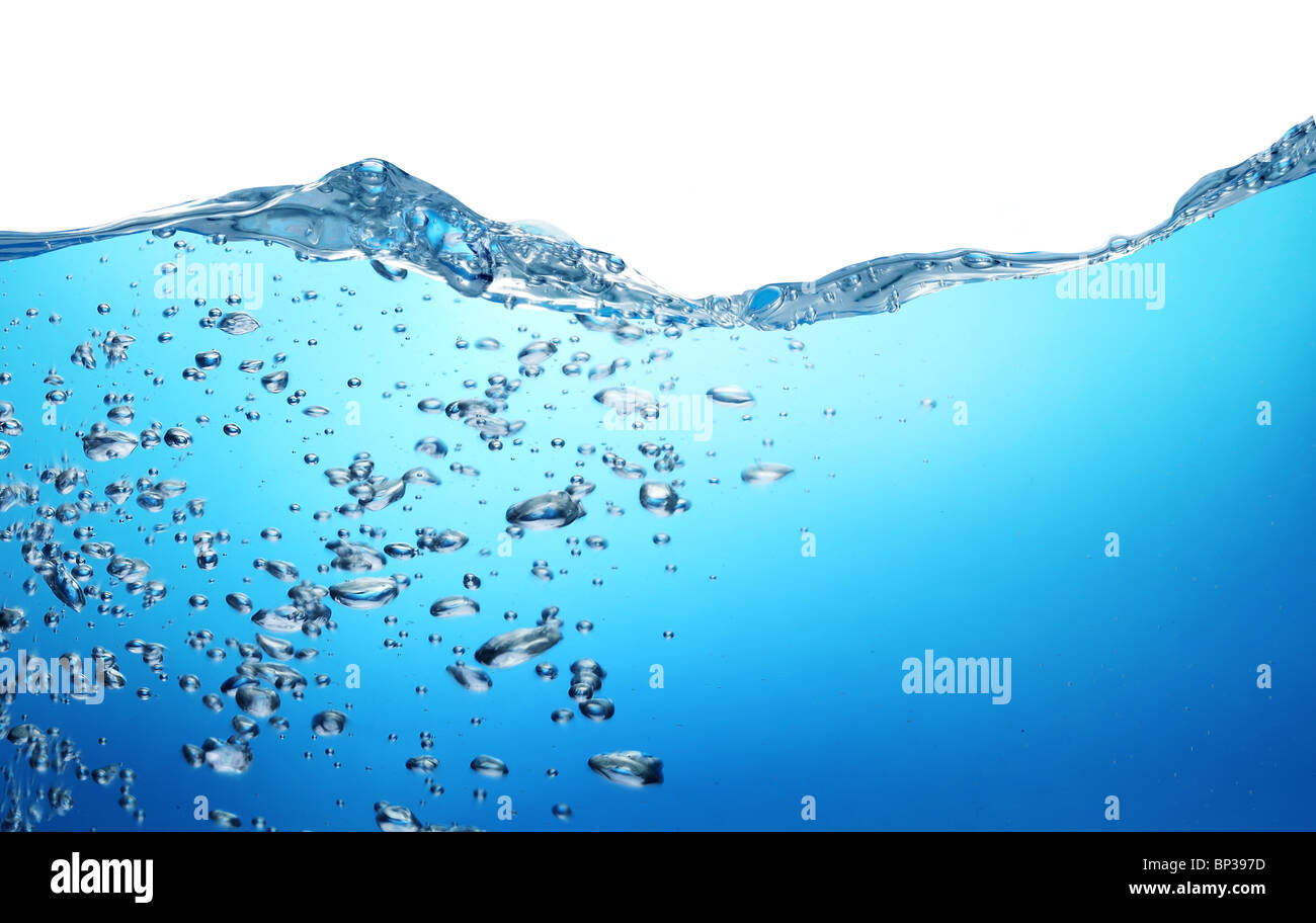 Air bubbles rise from the bottom of the ocean to the surface. Above the water is a white background. Stock Photo