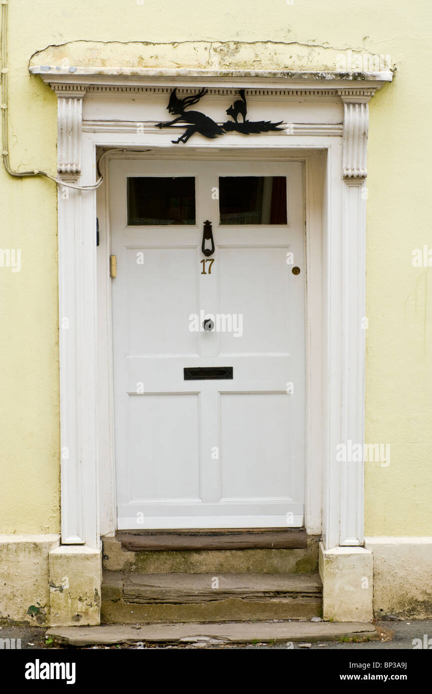 White painted wooden paneled front door no. 17 with knocker letterbox flat pediment and architrave of town house in UK Stock Photo