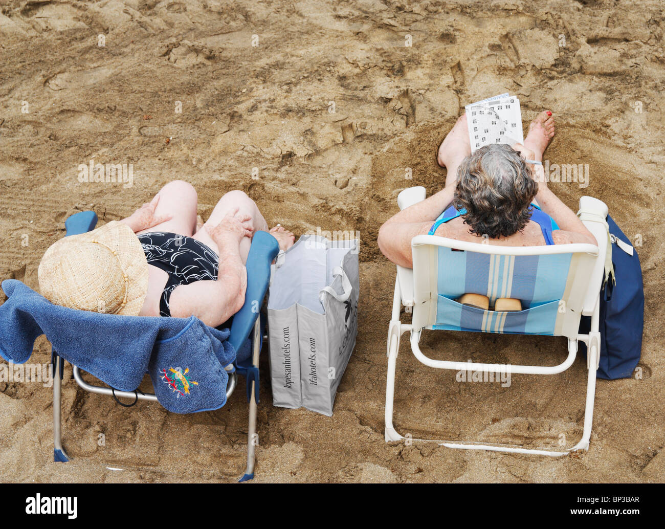 Old woman sunbathing on beach hires stock photography and images Alamy