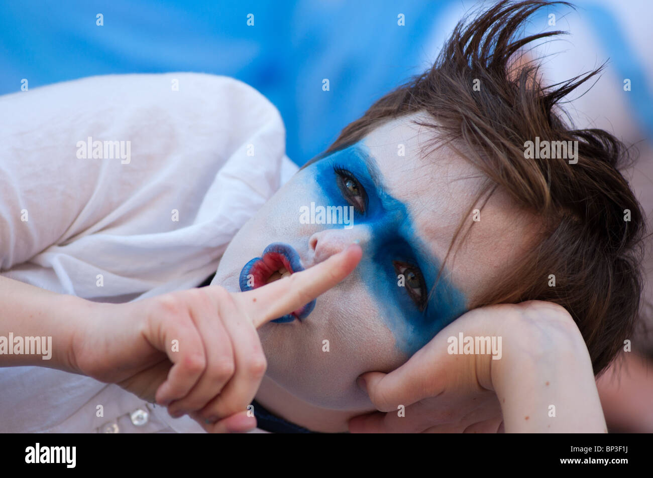Performer at Edinburgh's fringe festival with face painted in Scotland's national colours. Stock Photo