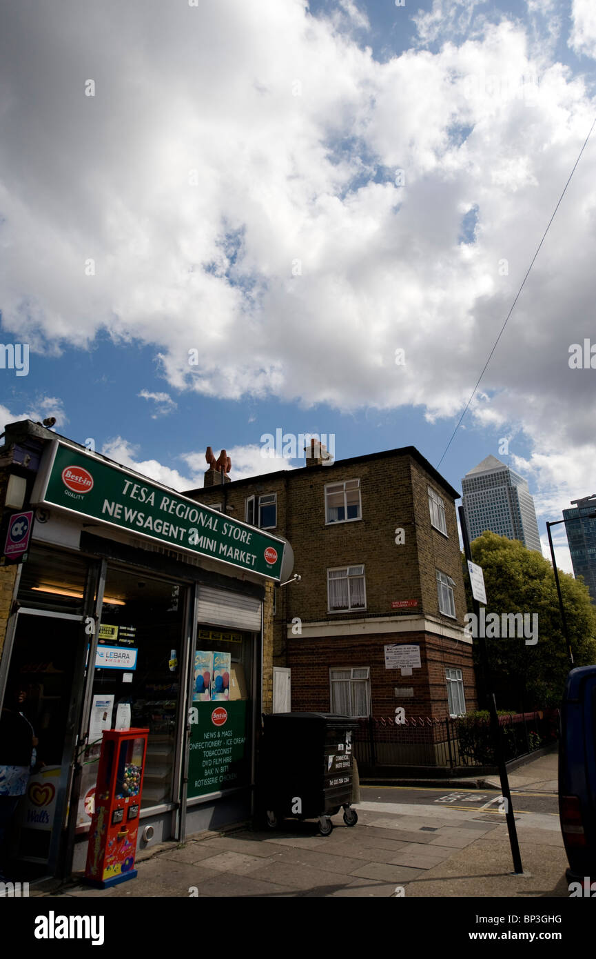 Convenient store in a poor area of East London with the richer symbols of the city in the background, such as Canary Wharf Stock Photo