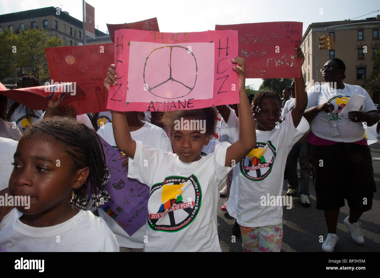 Hundreds march through the streets of Harlem in the Harlem Children's