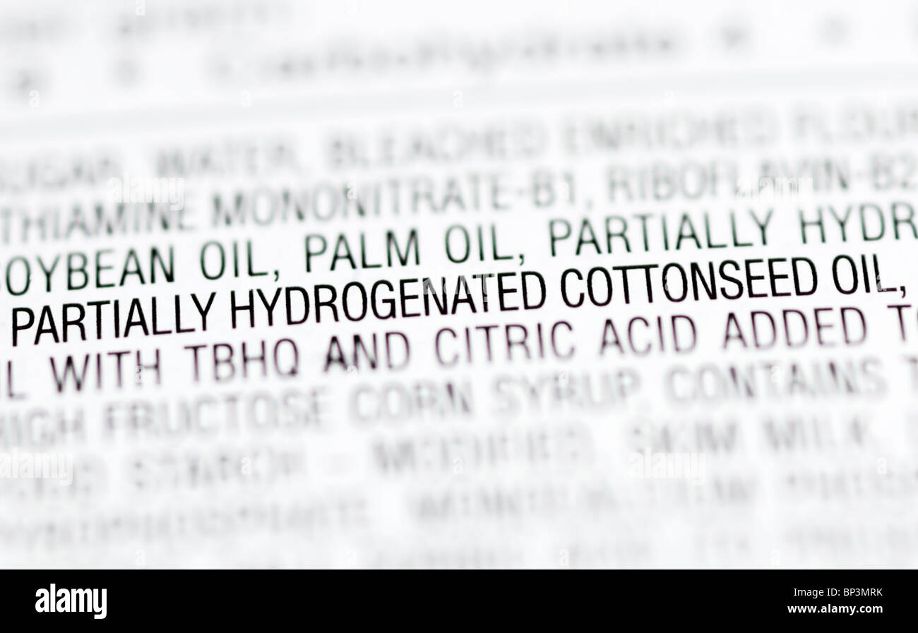 Part of the ingredients list from a package of cupcakes highlighting partially hydrogenated oils (trans fats). Stock Photo