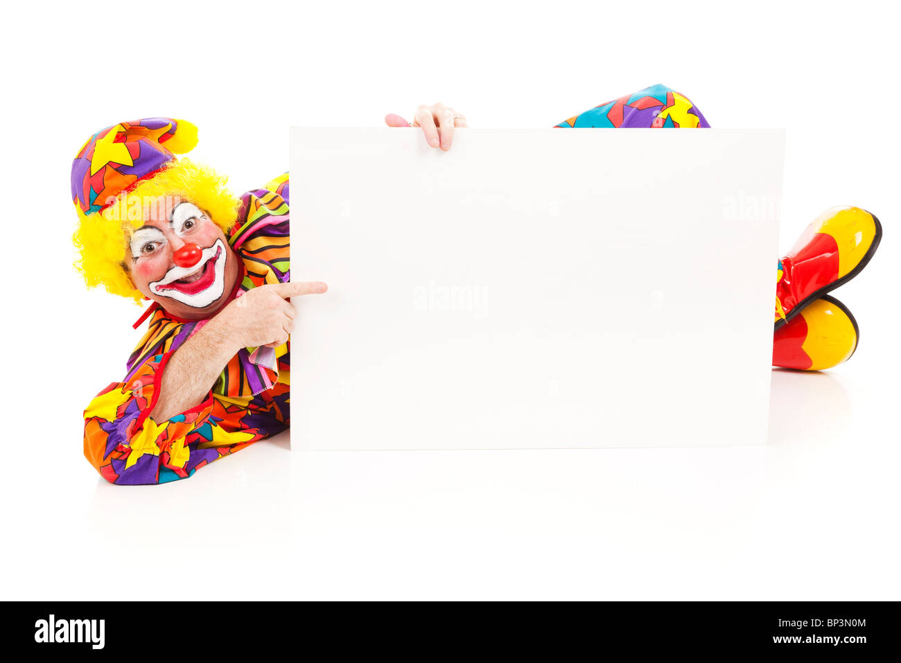 Clown lying on the ground holding a blank white sign. Full body ...