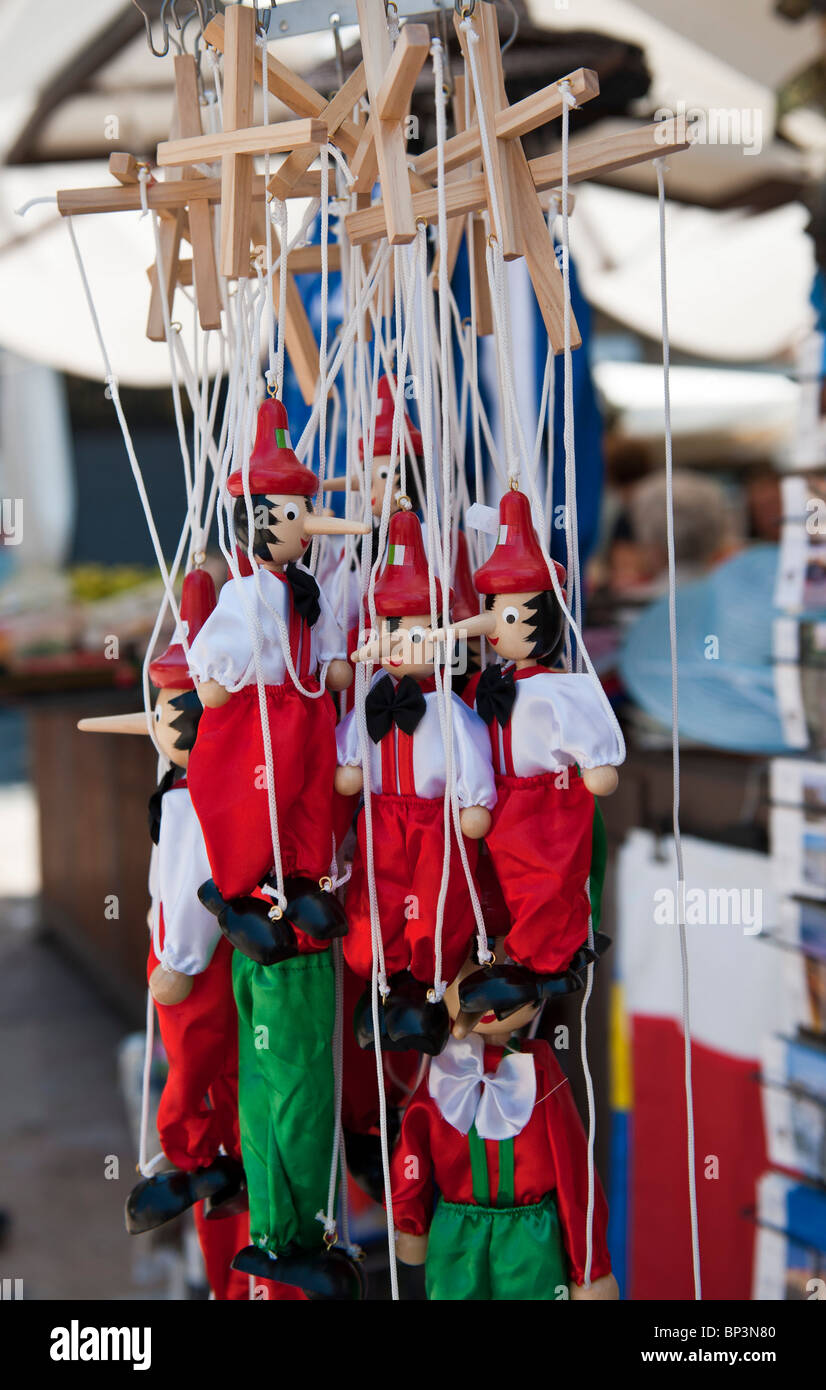 Pinocchio puppets for sale at market stall Stock Photo