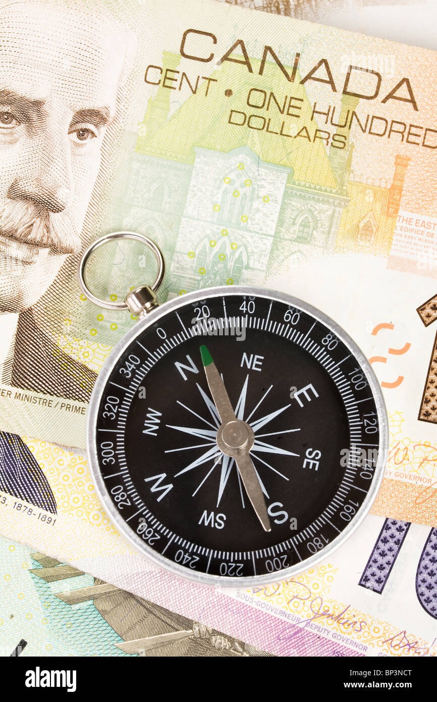Compass and canadian dollar close up shot Stock Photo Alamy
