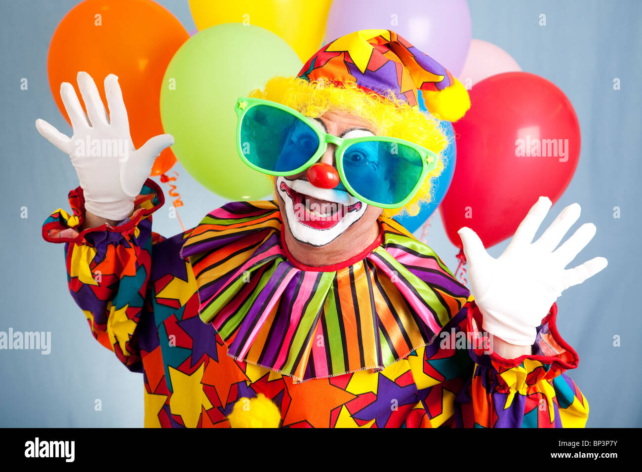 Funny birthday clown in hilarious oversized sunglasses Stock Photo - Alamy