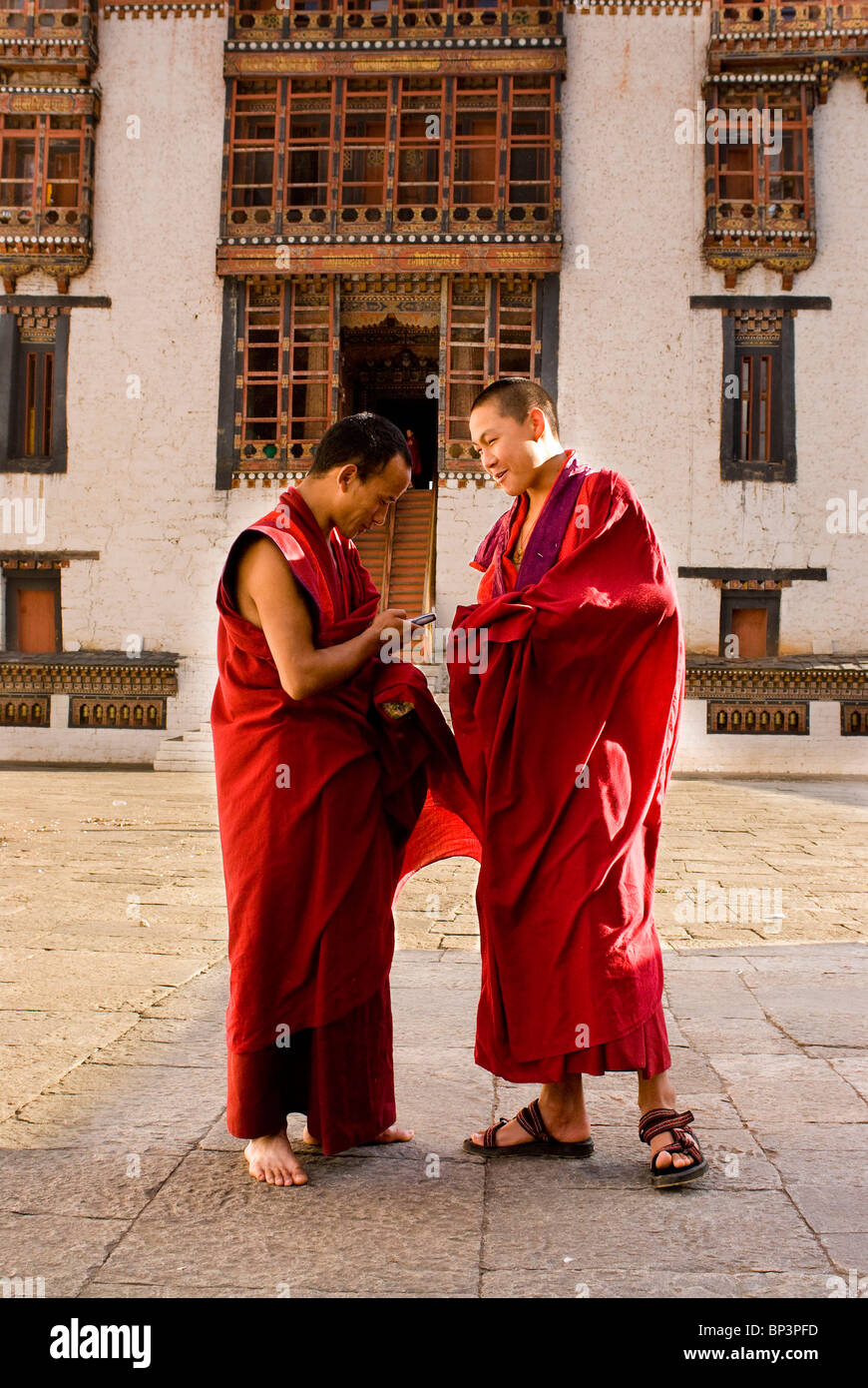 Buddhist Monks playing with their new cell phones, Thimpu Dzong, Bhutan, not model released Stock Photo