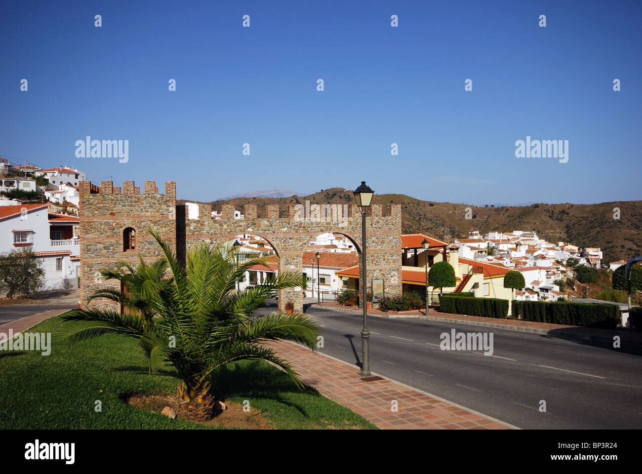 Castle style entrance arch, Whitewashed village (pueblo blanco), Moclinejo, Costa del Sol, Malaga Province, Andalucia, Spain. Stock Photo