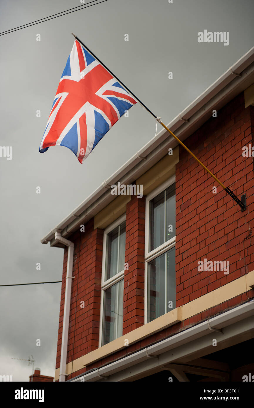 Union Jack flag flying outside terraced house in Oakengates, Telford, West Midlands, England UK Stock Photo