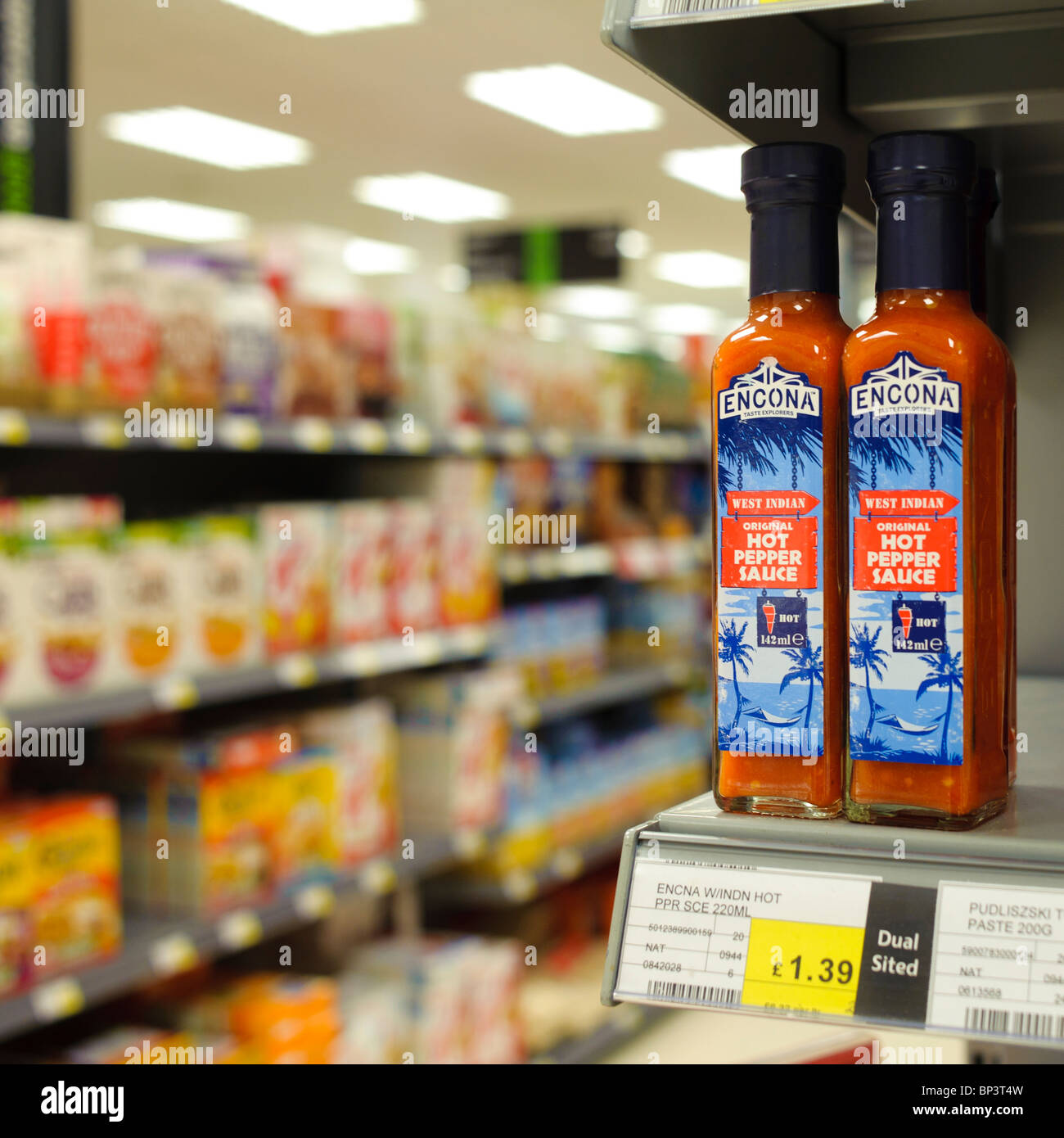 Bottle of Encona hot pepper sauce on a shelf at CoOp supermarket, UK