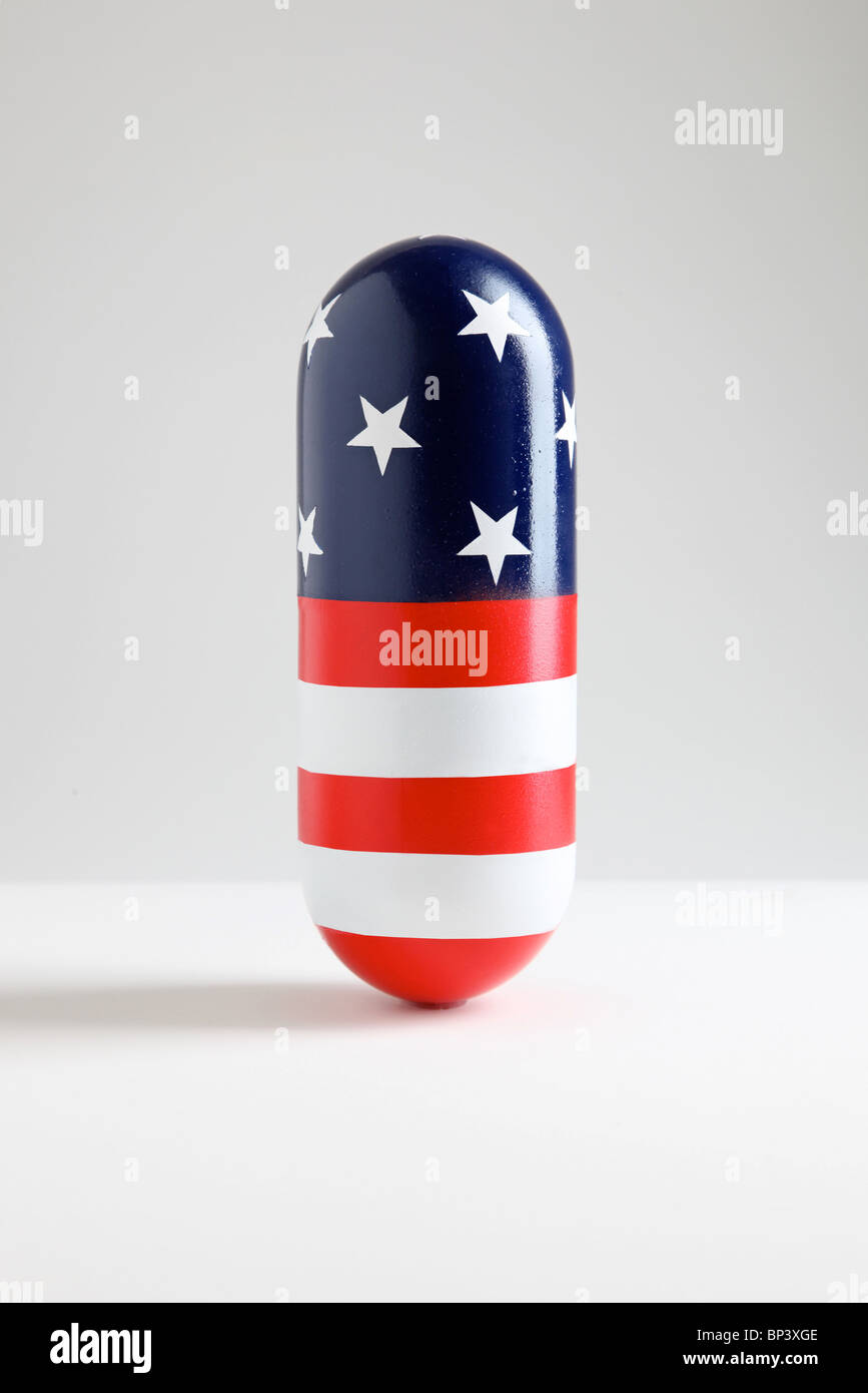 giant pill capsule with American Flag pattern of stars and stripes Stock Photo