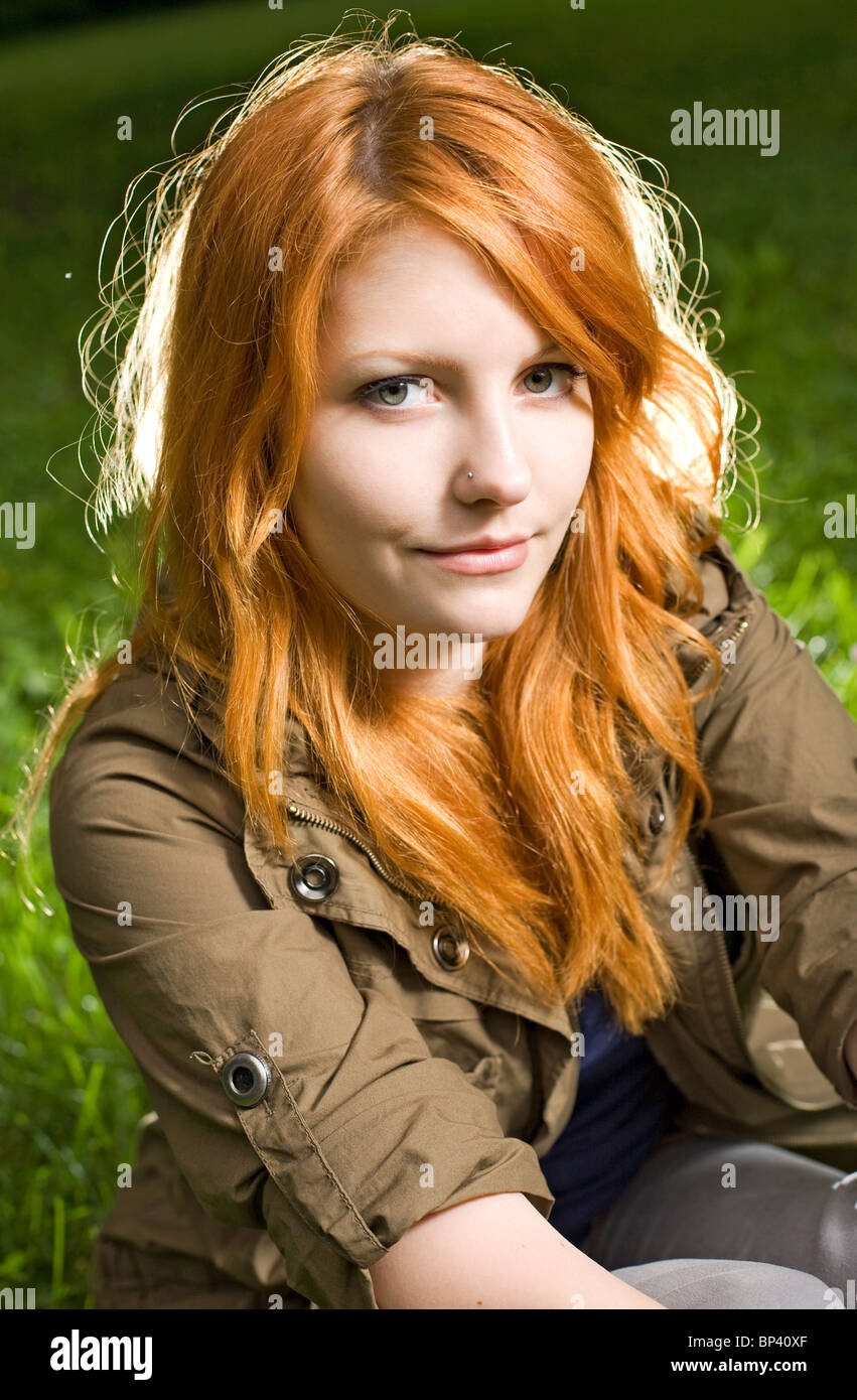 Beautiful redhead teen giving a tight smile for the camera Stock Photo -  Alamy