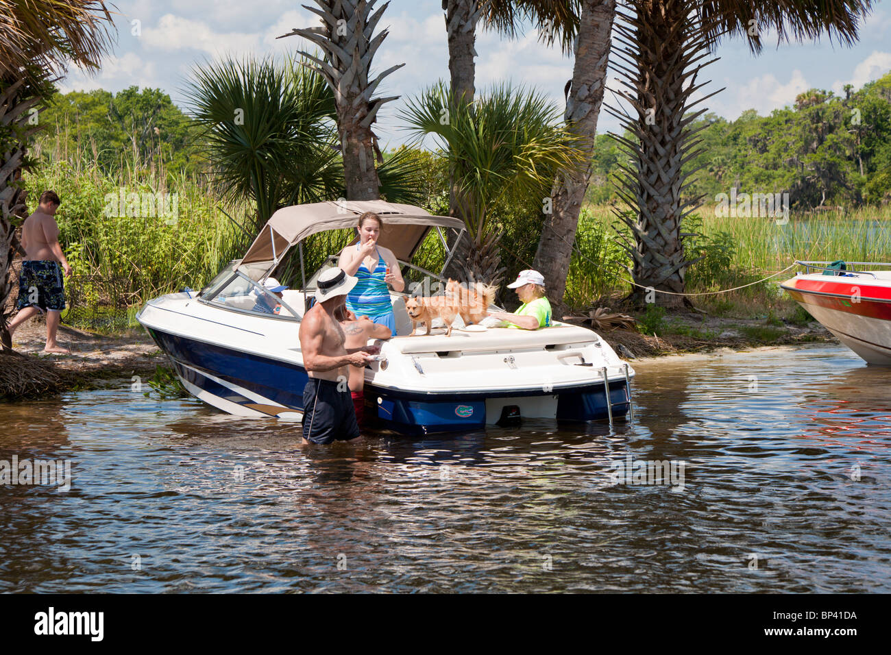 Salt Springs, FL - May 2010 - Family with dog takes a break from boating along the bank of the Salt River in central Florida Stock Photo