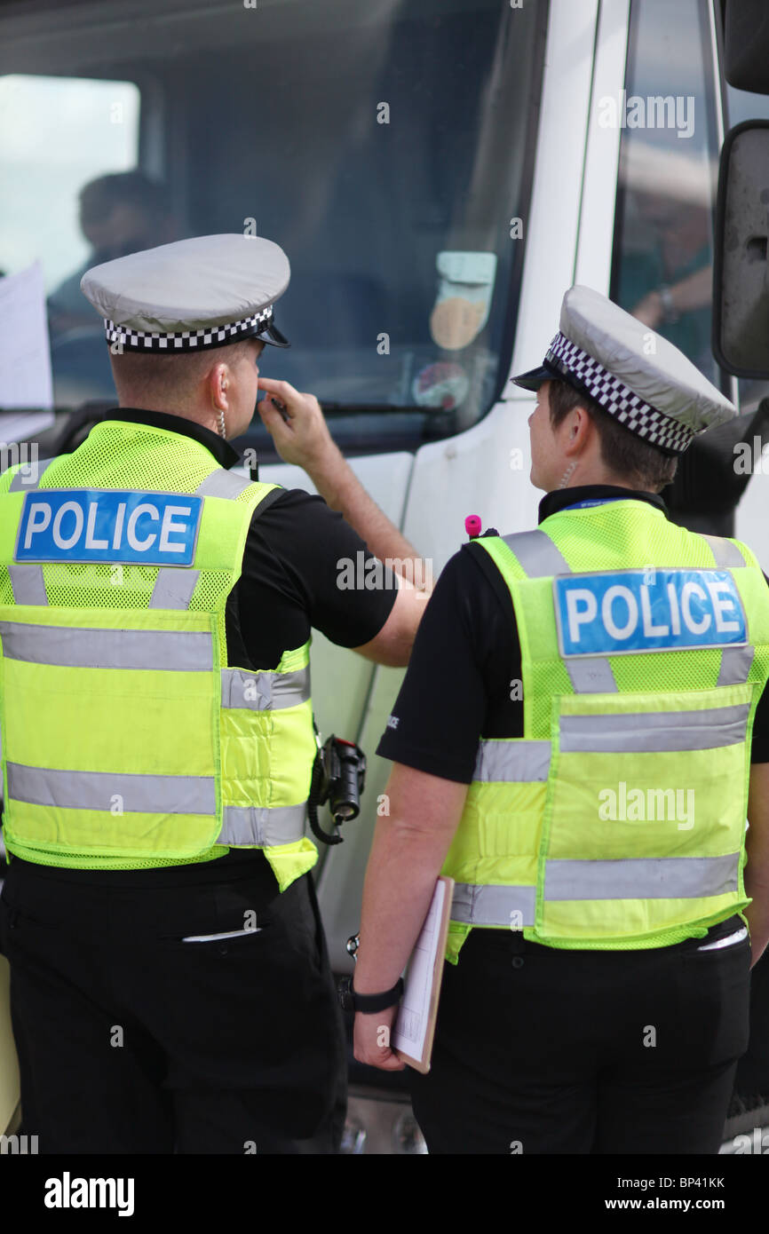 UK police stopping a vehicle on a British road in hi vis vests and grey hats Stock Photo