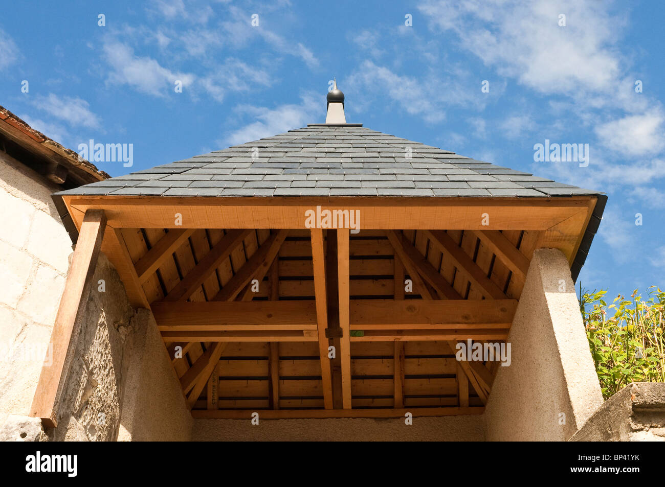 Underside timber construction detail of garden shelter - France. Stock Photo