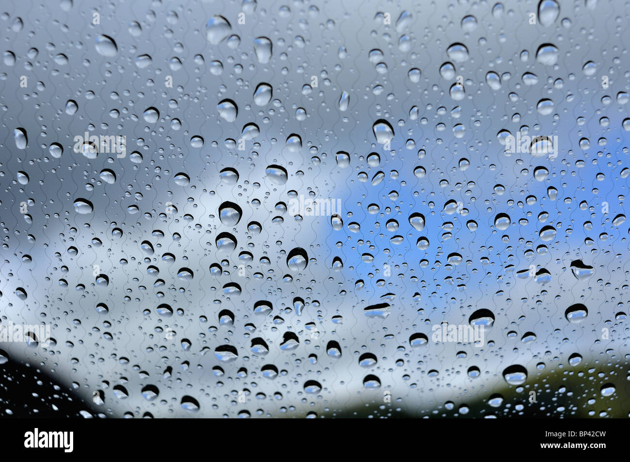Raindrops on a car windscreen after a heavy shower Stock Photo