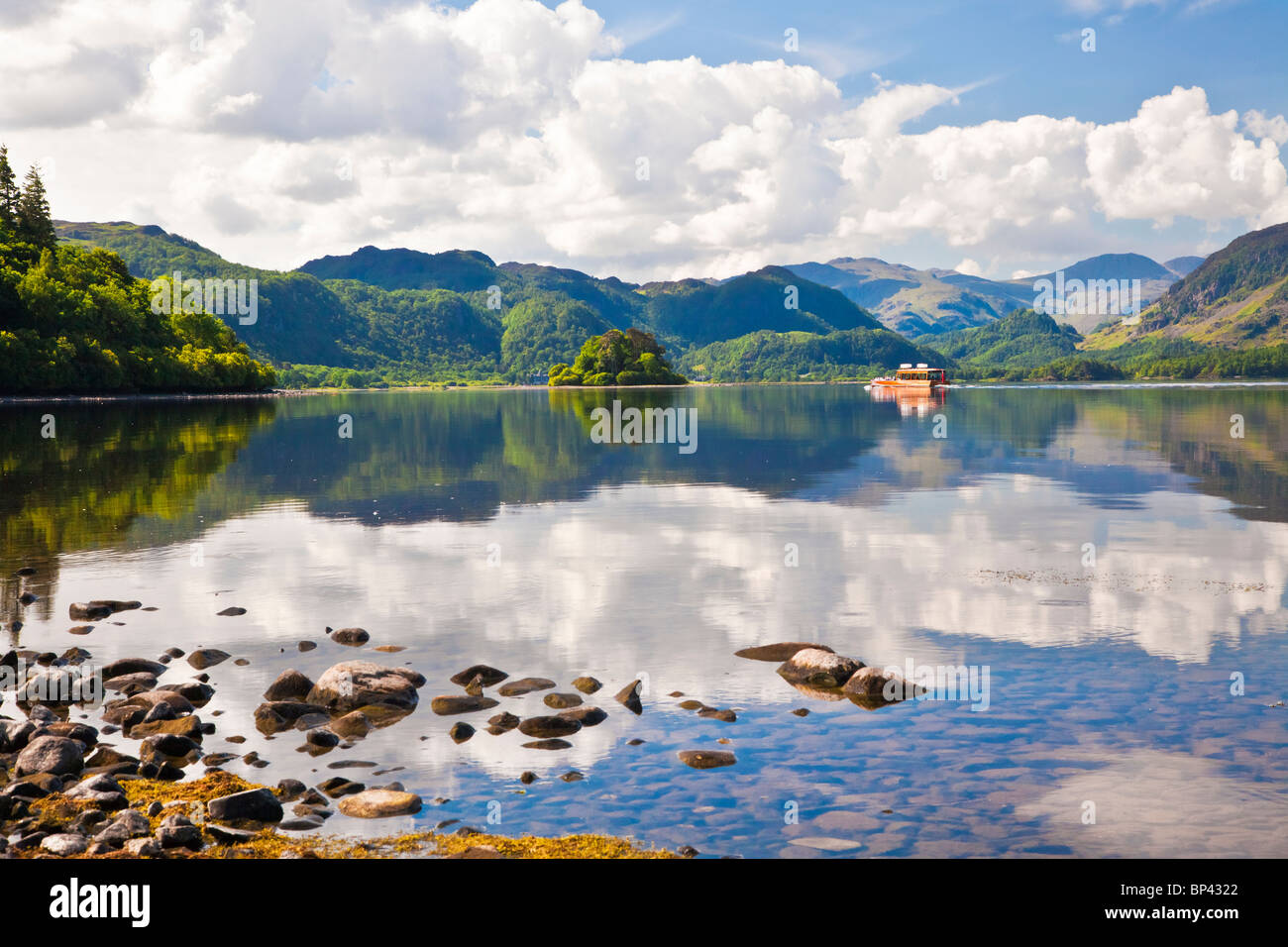 Pleasure launch or boat on Derwent Water, Castle Crag in the distance in the Lake District National Park, Cumbria, England, UK Stock Photo