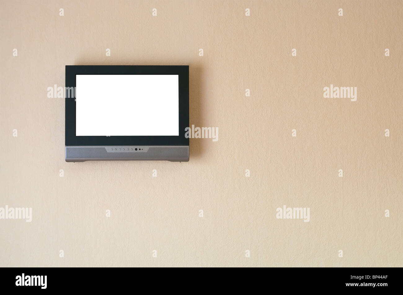 Liquidcrystal television receiver on wall. Isolated white screen. Copy