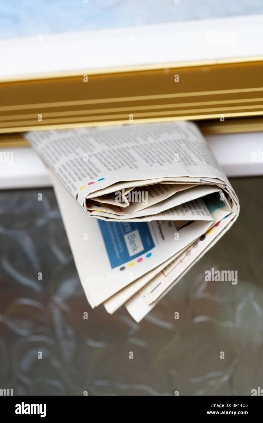 local newspaper delivery stuck in the letterbox in northern ireland uk