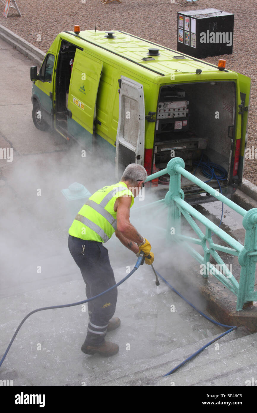 A street cleaner using a high pressure jet wash in the U.K Stock Photo
