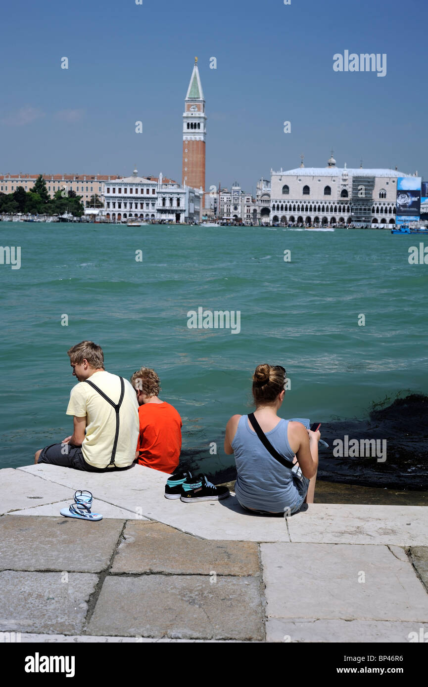A group of caucasian Tourists at quayside with a landscape of San Marco district, Venice/ Italy Stock Photo
