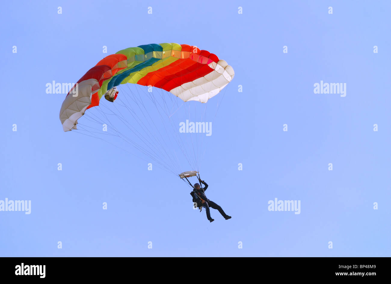 Parachutist pulling right handle and turning right. Stock Photo