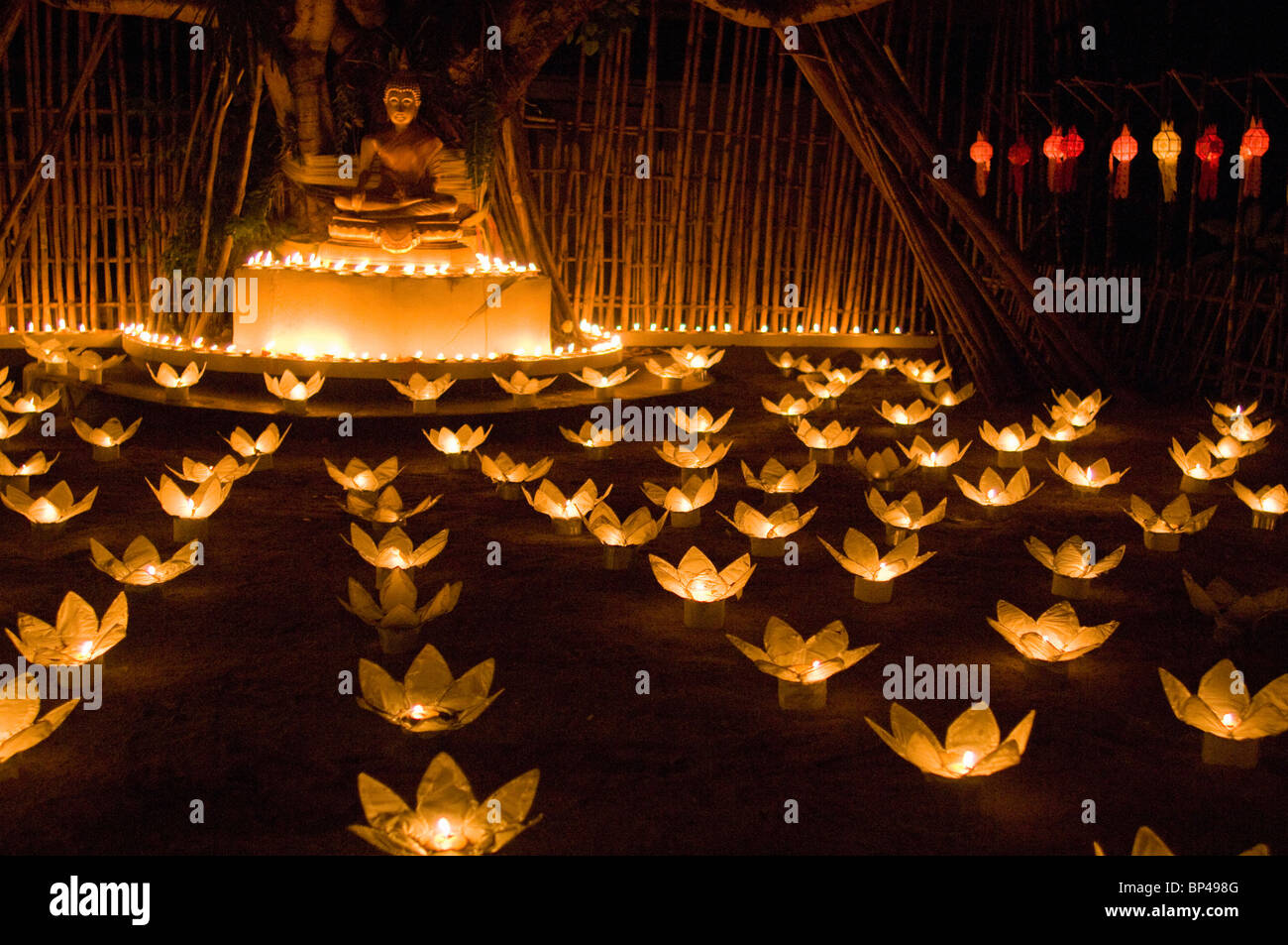 Monks lighting khom loy candles and lanterns for Loi Krathong festival. Stock Photo