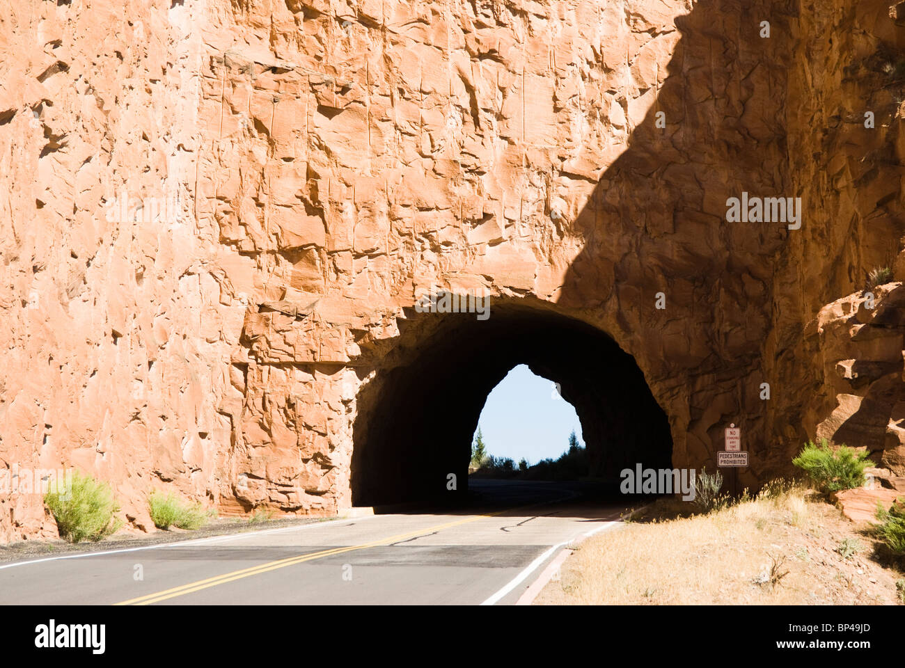 A tunnel through a sandstone wall on the Rim Rock Drive in the Colorado