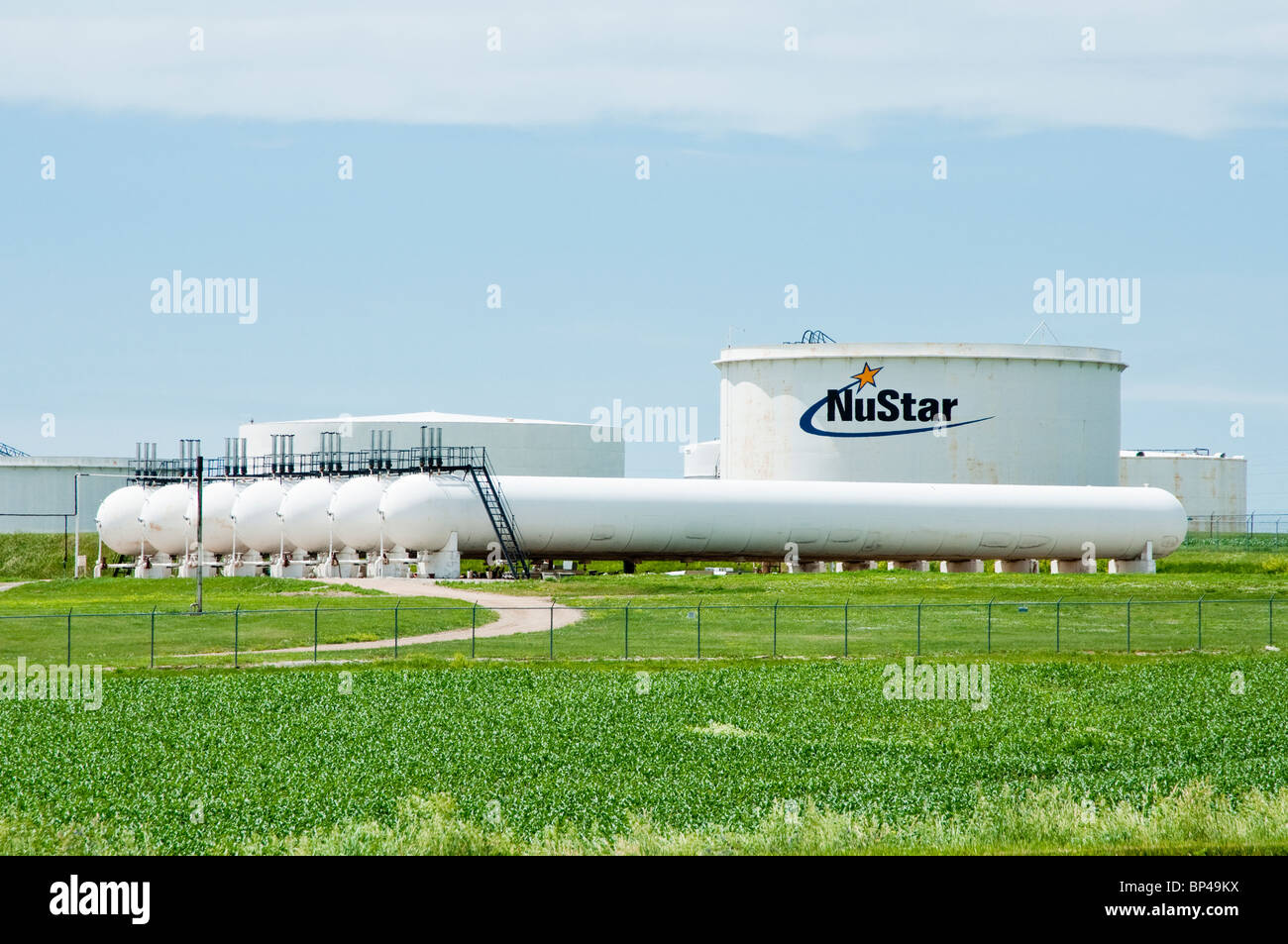 A petroleum storage and distribution terminal on a pipeline in Nebraska. A corn field is seen in the foreground. Stock Photo