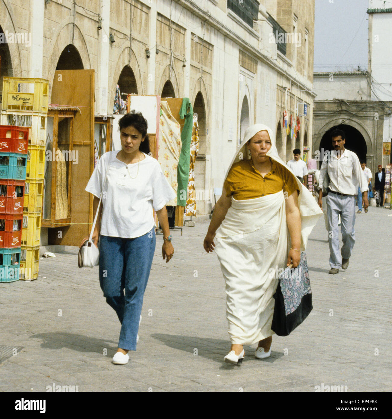 Tunis, Tunisia. Tunisian Women, Modern and Traditional Dress Styles, Side by Side. Stock Photo