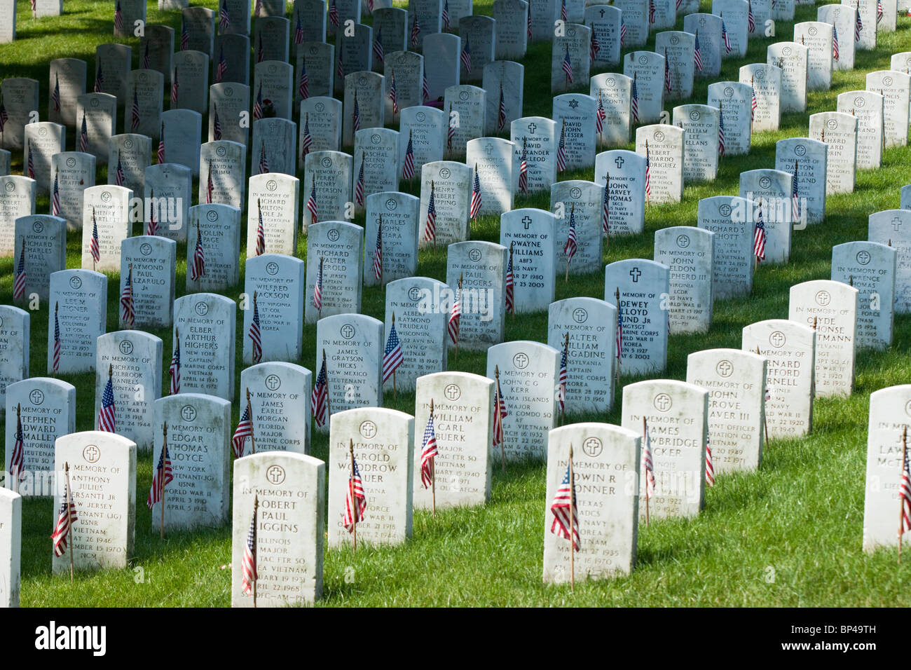 An American flag lines each gravestone in remembrance of soldiers killed in battle on Memorial Day in Arlington National Cemeter Stock Photo
