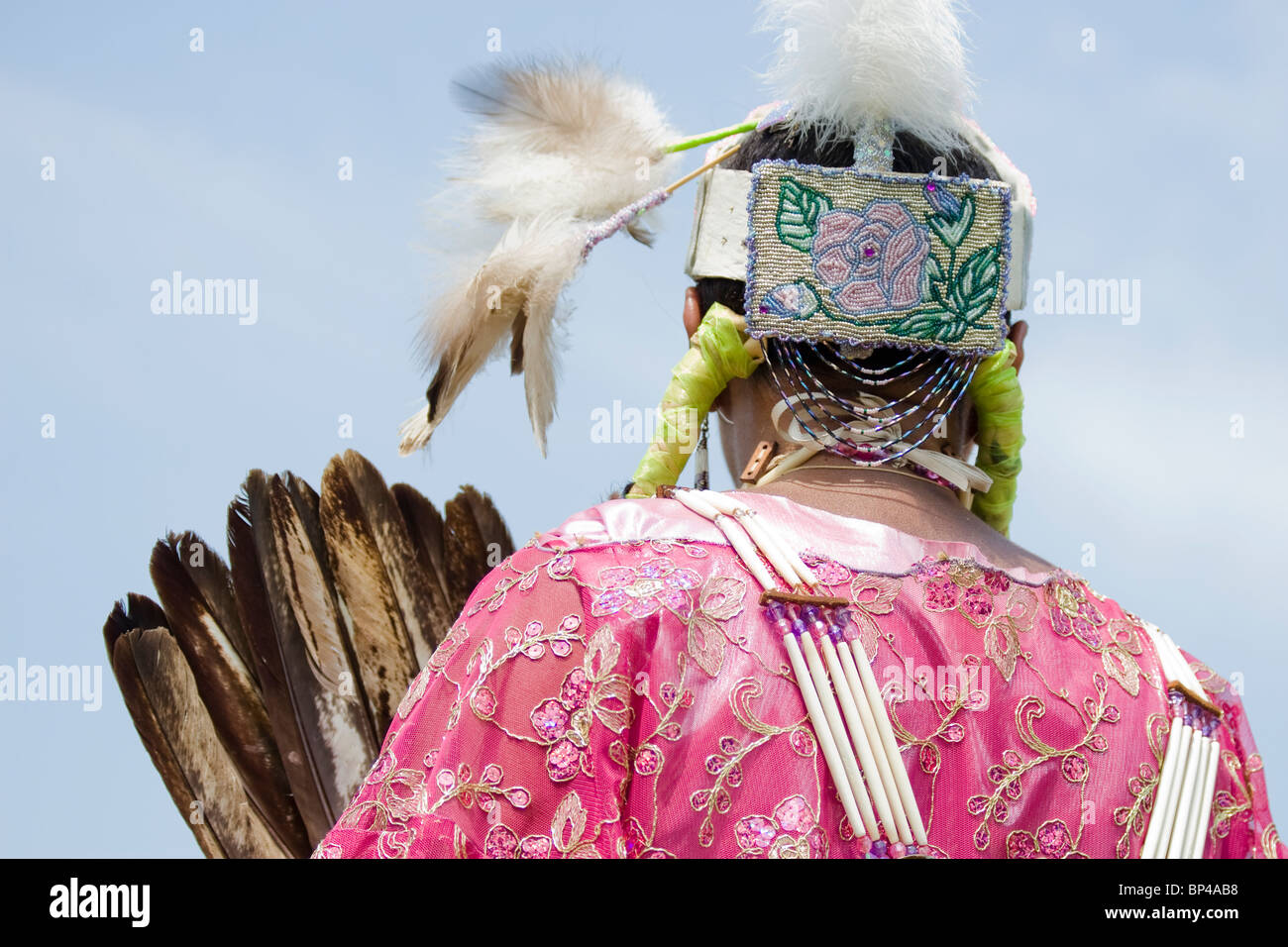 A Native American woman dances in full traditional regalia at the 8th Annual Red Wing PowWow in Virginia Beach, Virginia. Stock Photo
