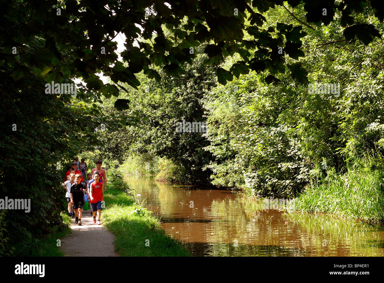 UK, England, Cheshire, Stockport, Romiley, Peak Forest Canal, children walking along towpath Stock Photo