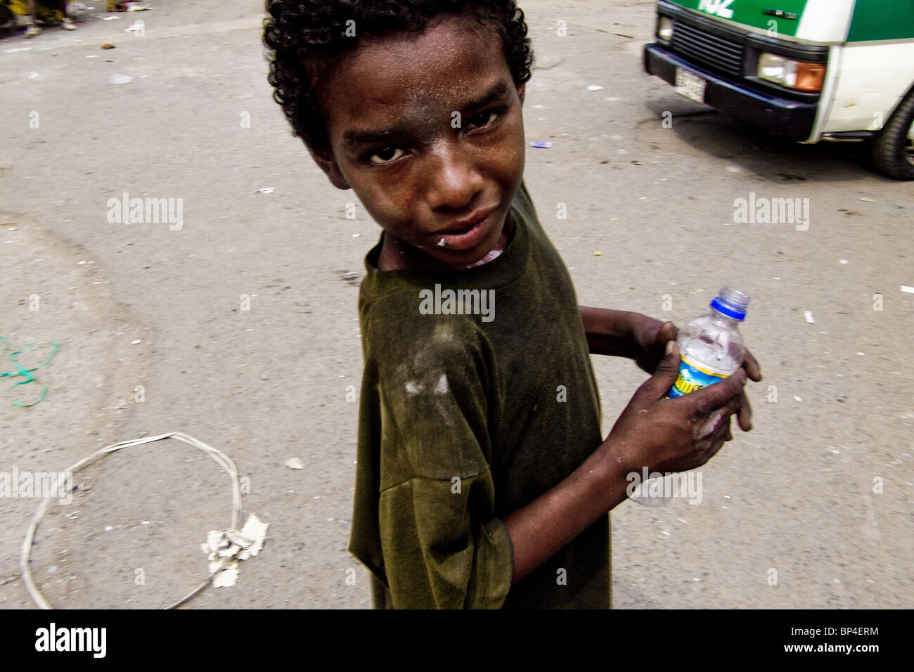 A Colombian street kid getting high by sniffing the shoe glue in the slum of Calvario, Cali, Colombia. Stock Photo