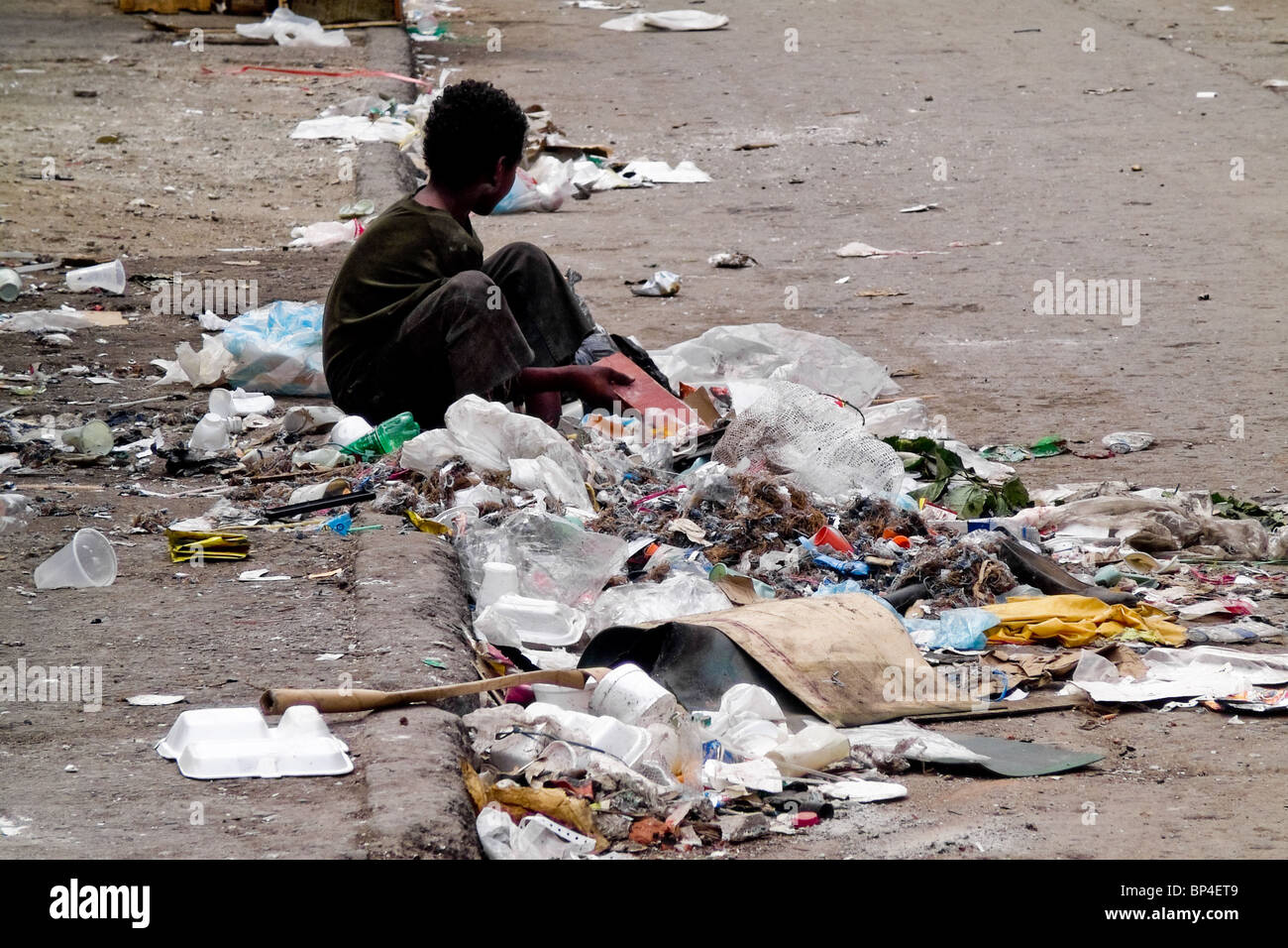 A Colombian street kid recollecting garbage in the slum of Calvario, Cali, Colombia. Stock Photo