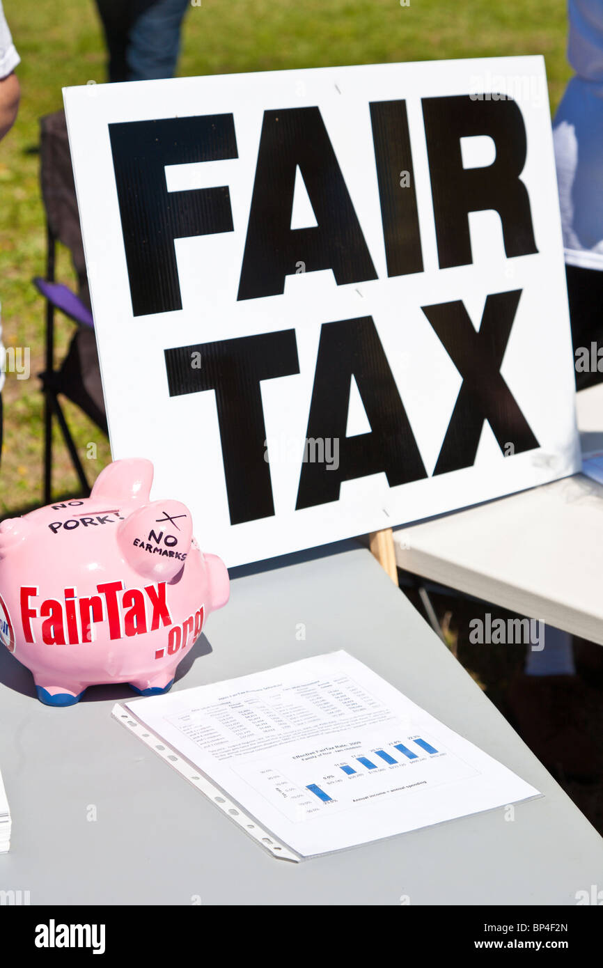 Fair tax sign and piggy bank on table with petitions at a Tea Party political event at Farran Park in Eustis, Florida Stock Photo