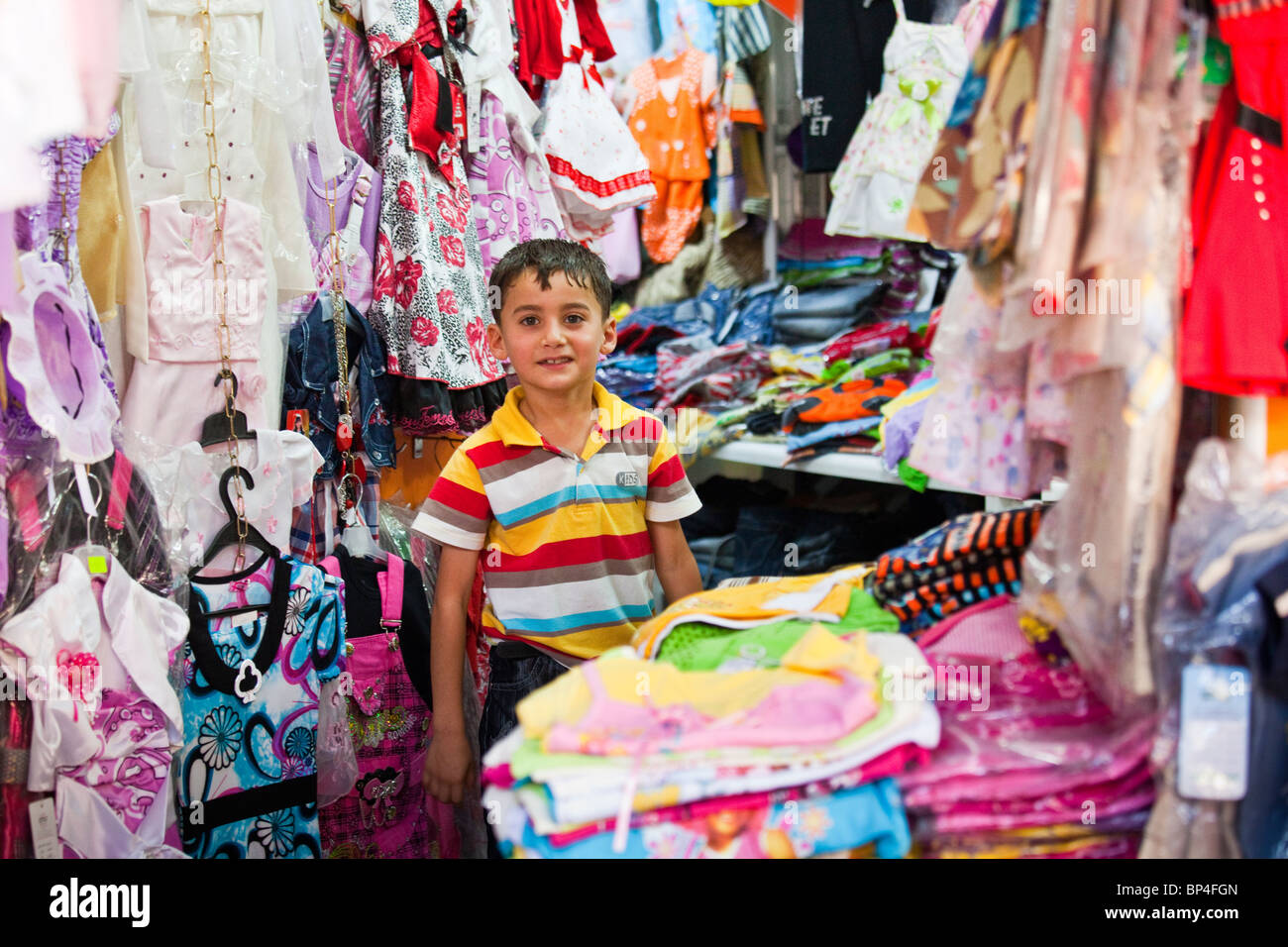 Kurdish Iraqi boy at his father's shop in the bazaar, Dohuk, Kurdistan, Iraq Stock Photo