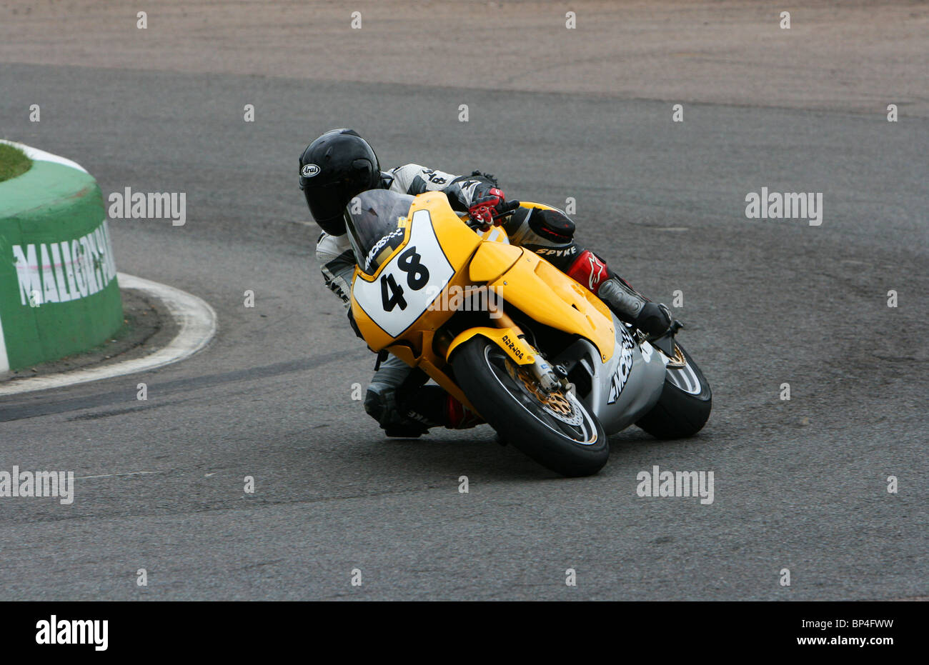 Motorbike accelerating out of Shaw's Hairpin at Mallory Park Stock Photo