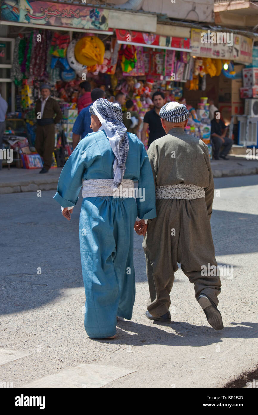 Elderly Muslim Kurdish Iraqi men holding hands in Dohuk, Kurdistan, Iraq Stock Photo