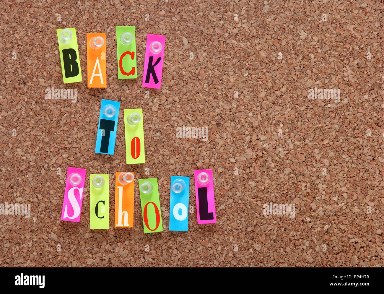 Back to School Letters Pinned onto Cork Board With Push Pins Stock