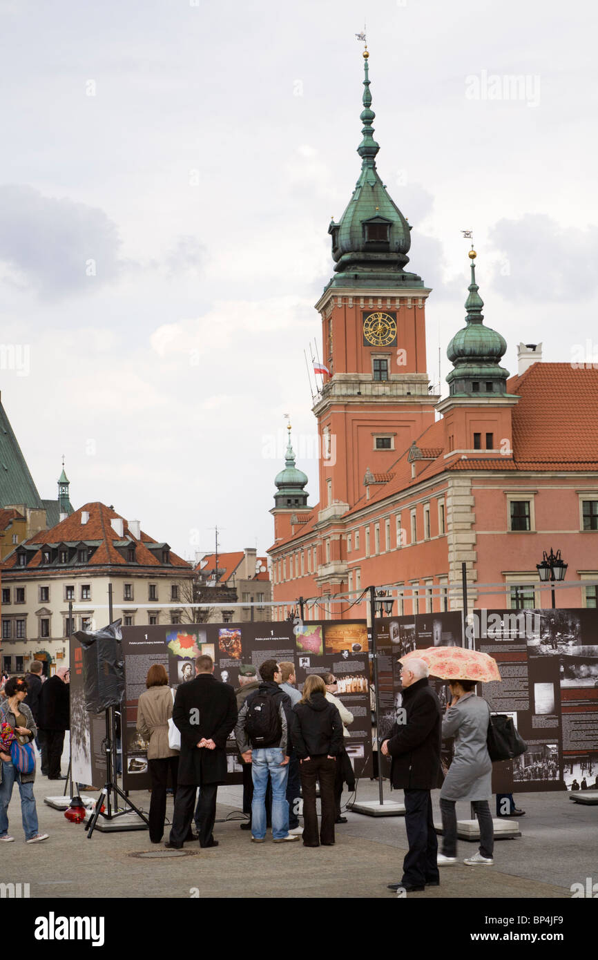 Castle Square, Warsaw Poland: People looking at an outdoor exhibition about the 1939 German and Soviet invasions of Poland. Stock Photo