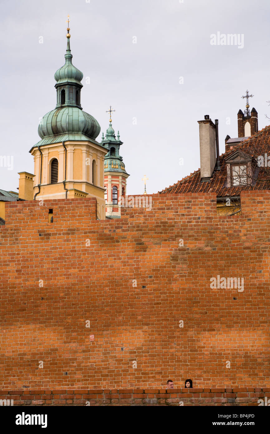 People sitting by Old Town defensive walls, Warsaw Poland. Stock Photo