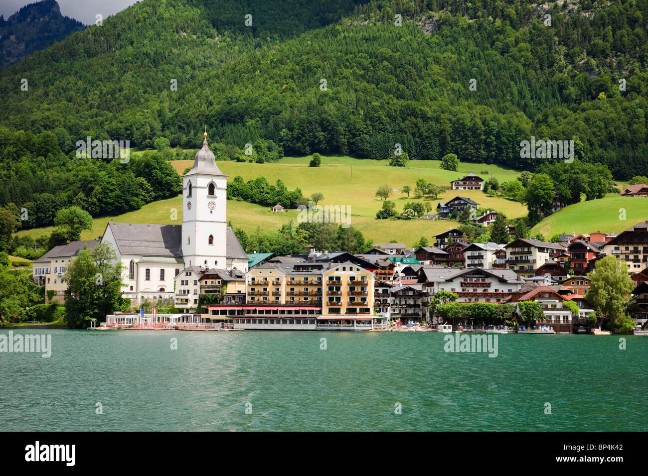 St Wolfgang, Salzkammergut, Upper Austria, Austria, Europe. View of town waterfront buildings and church from Wolfgangsee lake Stock Photo